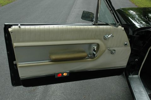 1964 Ford Galaxie - Interior view of a 1964 Ford Galaxie door panel, showing the beige upholstery and chrome accents.