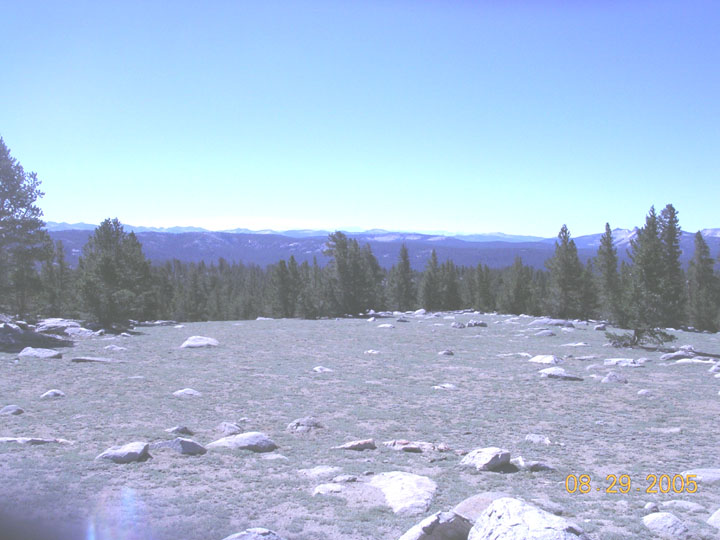 Mountain landscape with trees, rocks, and a clear blue sky. Date stamp reads 08/29/2005