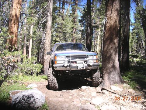 1994 Ford Bronco - A blue pickup truck navigates a rocky forest trail, with a date stamp of 08/27/2005 visible.