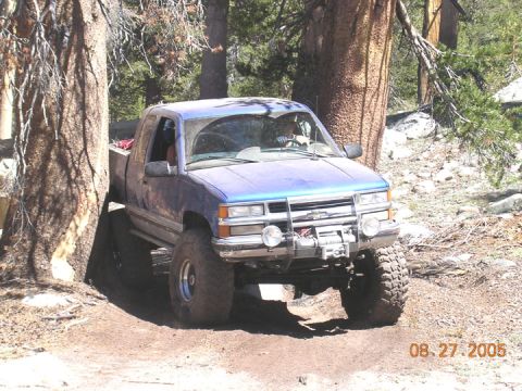 1994 Ford Bronco - This pickup truck is equipped for off-road use, with a winch and large tires visible.
