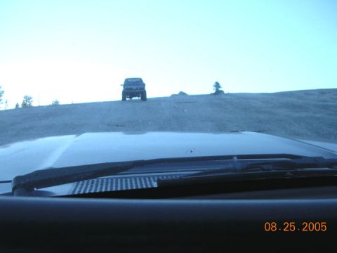 1994 Ford Bronco - A dark SUV is visible on a hill, with the date 08.25.2005 stamped on the image.
