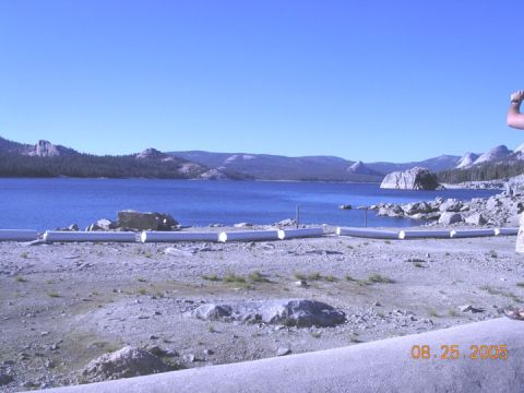 1994 Ford Bronco - A scenic view of a lake and mountains, with a concrete barrier in the foreground showing a date stamp.