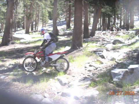 1994 Ford Bronco - A dirt bike rider navigates a rocky, wooded trail on August 27, 2005.