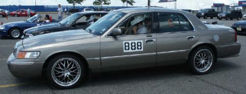 2001 Mercury Grand Marquis - This 2001 Mercury Grand Marquis is equipped with racing numbers and aftermarket wheels.