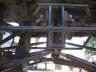 1990 Ford Bronco - The photo shows the underside of a building's roof structure, with exposed wooden beams and metal supports.