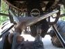 1990 Ford Bronco - A low-angle view of a vehicle's undercarriage, highlighting its modified suspension and large tires.
