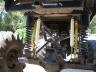 1990 Ford Bronco - Close-up of the undercarriage, highlighting the suspension system and off-road tire.