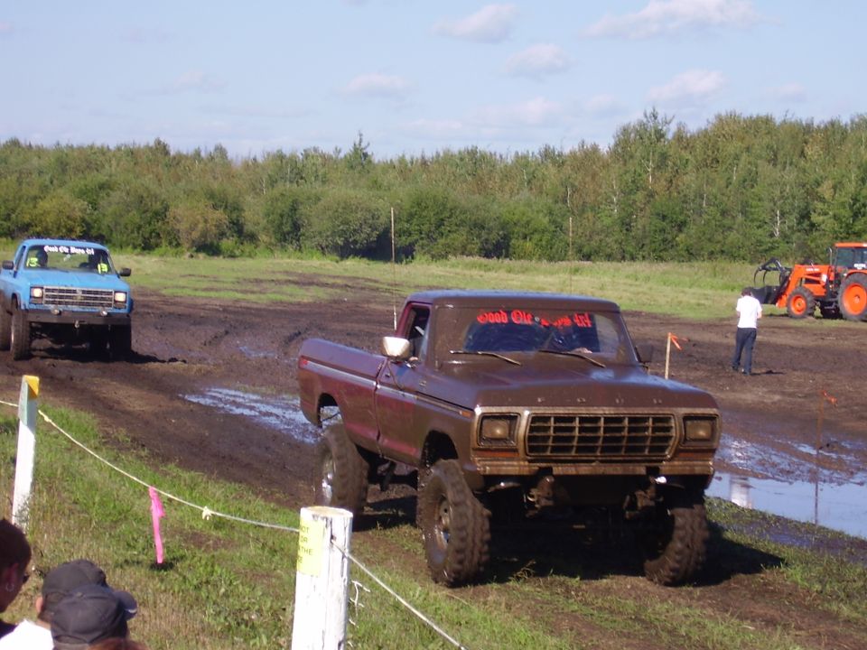 Brown 1979 Ford F-250 in mud pit, text on windshield reads 'Good Old Days'