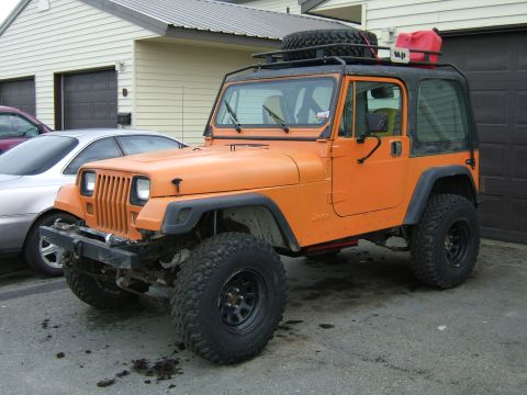 1989 Jeep YJ - This 1989 Jeep YJ is equipped with a roof rack and an auxiliary gas can.