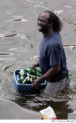 1993 Ford Bronco - A man walks through flooded water carrying a tub of bottles.