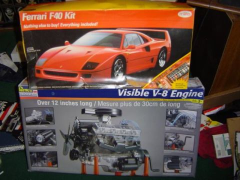 1979 Ford Bronco - Two model kits are stacked, one for a Ferrari F40 and another for a visible V-8 engine.