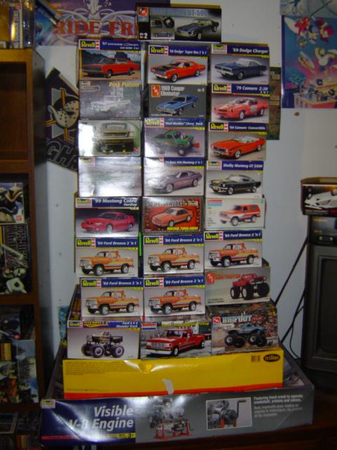 1979 Ford Bronco - A collection of model car kits is displayed on shelves, various vehicles and engine models.