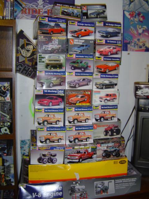 1979 Ford Bronco - A collection of model car kits is neatly stacked, various vehicles and trucks.