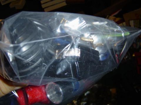 1979 Ford Bronco - Automotive parts are contained within a clear plastic bag.