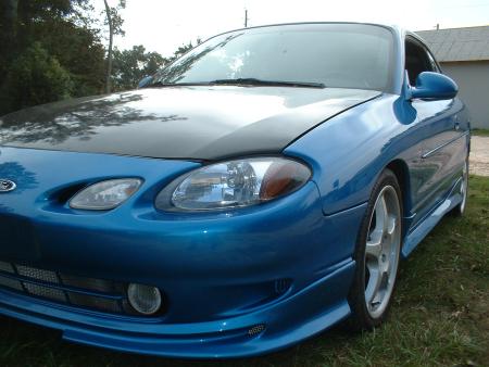 2000 Ford Escort - This blue 2000 Ford Escort ZX2 coupe is shown from a 3/4 front angle, highlighting its sporty body style.
