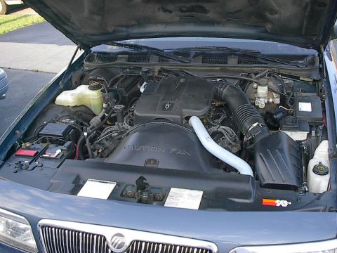 1985 Mercury Grand Marquis - Engine bay view of a blue 1996 Mercury Grand Marquis, showing the engine and surrounding components.