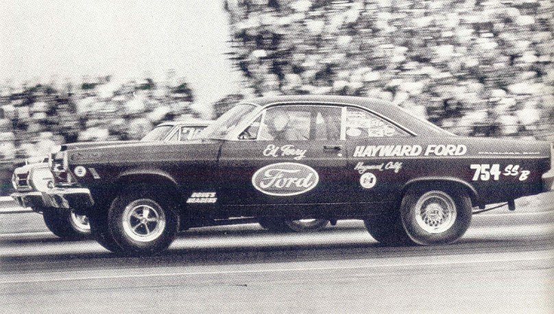 Vintage black Ford funny car drag racer lettered Hayward Ford on a strip