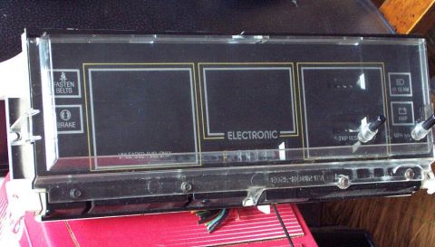1985 Ford LTD Crown Victoria - This electronic instrument cluster displays warning lights and has a clear protective cover.