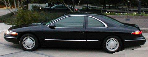 1994 Lincoln Mark VIII - Side profile of a 1994 Lincoln Mark VIII coupe parked outdoors.