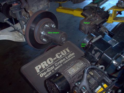 1983 Ford Bronco - On-car brake lathe being set up. The adapter is installed & the cutter base is positioned on its arm to align with the rotor. Then the driv…
