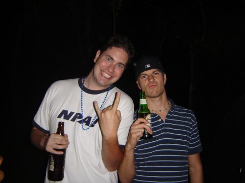 1995 Ford Probe - Two men pose for a photo while holding beer bottles and making hand gestures.