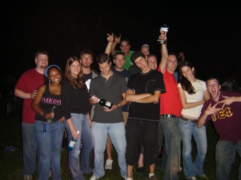 1995 Ford Probe - A group of friends gathers for a nighttime photo, with one person proudly holding a trophy aloft.