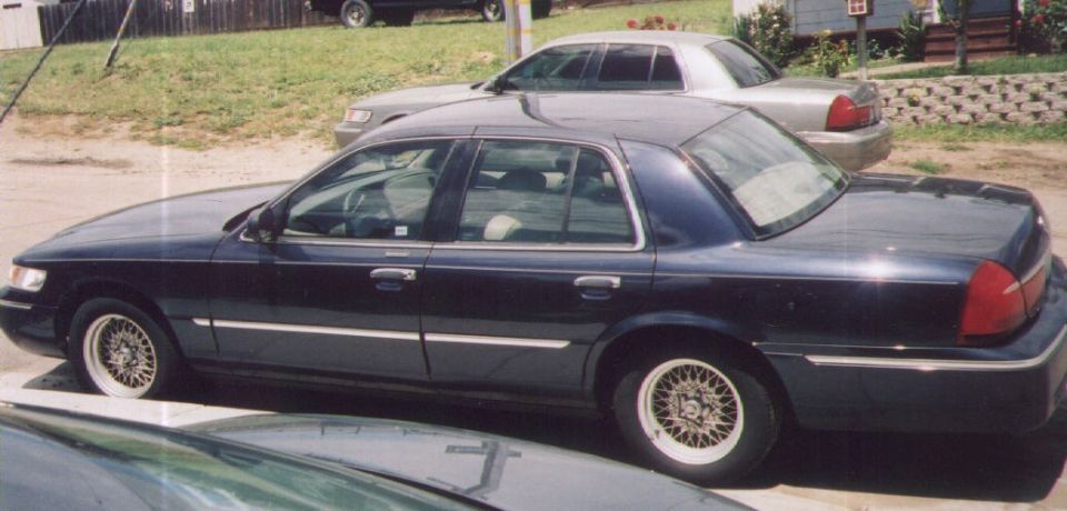 Dark blue 2000 Mercury Grand Marquis sedan, side view