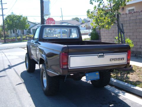 1985 Ford Ranger - This 1985 Ford Ranger pickup truck features a lifted suspension and a two-tone paint scheme on the tailgate.