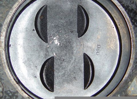 1986 Ford Bronco - Close-up of a piston top, showing the .060 measurement marking.
