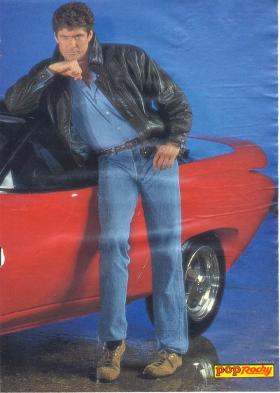 1991 Ford Bronco - David Hasselhoff poses with a red car, likely from the 1980s or early 1990s.