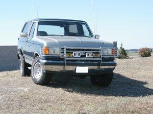 1989 Ford Bronco - This 1989 Ford Bronco is shown in a front 3/4 view, a prominent chrome grille guard and a silver exterior.