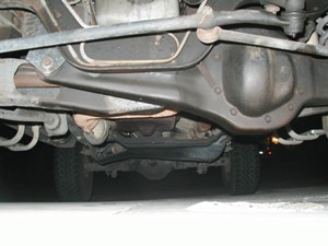 1989 Ford Bronco - A view of the undercarriage reveals the rear axle and suspension components of the vehicle. The SuperMotors.net logo is present.