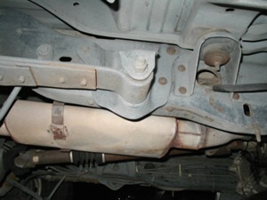 1989 Ford Bronco - The underside of a vehicle shows its exhaust system and suspension components.