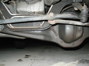 1989 Ford Bronco - A close-up view of the underside of a vehicle, revealing mechanical parts and suspension.