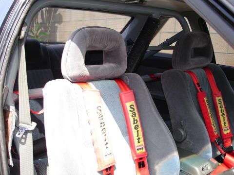 1989 Mazda MX-6 - Interior view of a car with racing seats and Sabelt harnesses, indicating performance modifications.