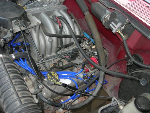 1996 Ford Bronco - Close-up view of the engine bay in a 1996 Ford Bronco, highlighting the intake manifold and wiring.