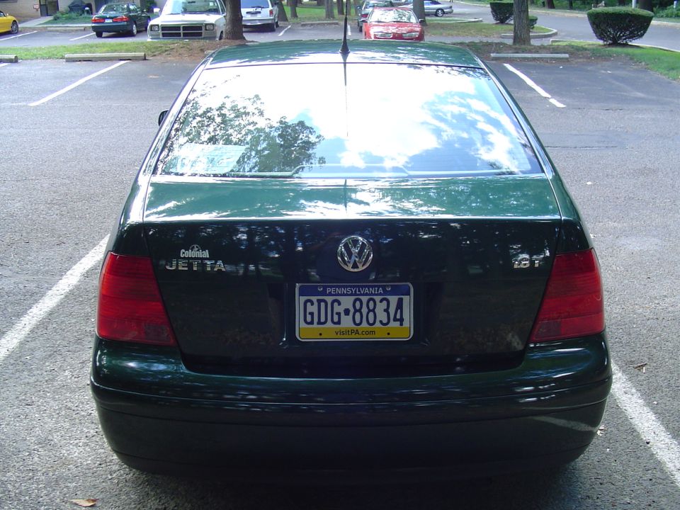 Rear view of a dark green Volkswagen Jetta 1.8T sedan with Pennsylvania plate in a parking lot