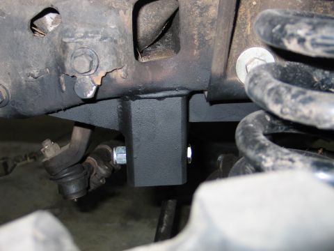 1992 Ford Bronco - This photo shows a custom bracket installed on the vehicle's frame, near the suspension components.