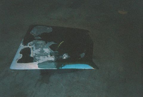 1972 Ford Ranchero - The hood of a vehicle is undergoing bodywork, with primer and filler visible.
