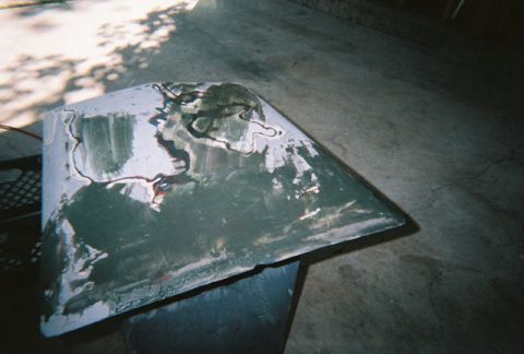 1972 Ford Ranchero - A car hood is shown with primer and body filler, indicating repair work in progress.