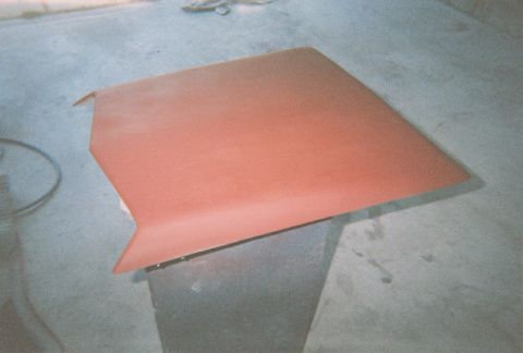 1972 Ford Ranchero - Hood panel, likely prepped for paint, sits on a workshop floor.