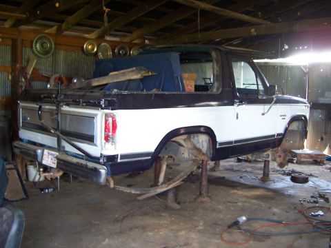 1983 Ford Bronco - This 1983 Ford Bronco is being worked on in a garage, lifted on jack stands.