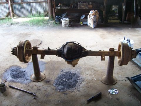 1983 Ford Bronco - Rear axle assembly, likely from a truck or SUV, shown in a garage setting.