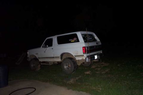 1988 Ford Bronco - This white 1988 Ford Bronco is seen from the rear quarter angle at night.