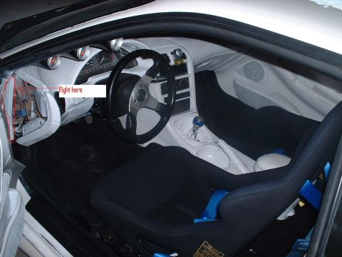 1993 Ford Probe - The interior of a car features racing seats and an aftermarket steering wheel, with some dashboard wiring exposed.