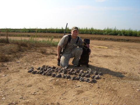 1990 Ford Bronco - A hunter and his dog pose with a successful hunt in a rural field.