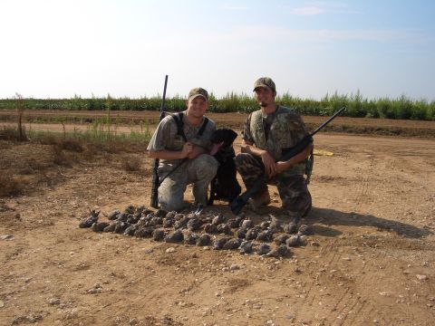 1990 Ford Bronco - Two hunters pose with their dog and a pile of game birds after a hunt.