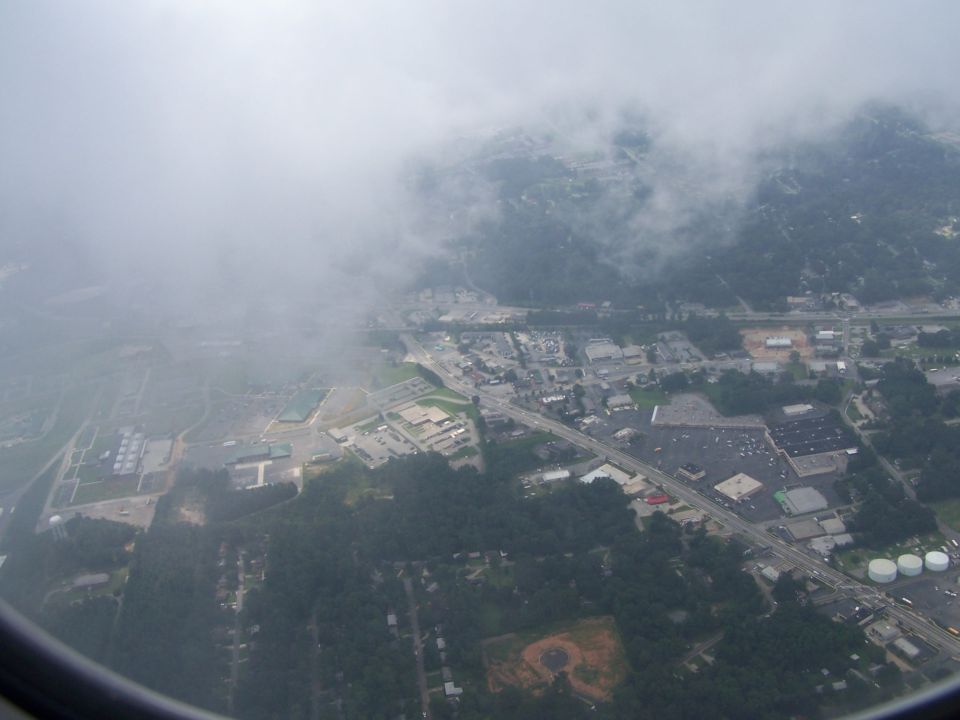Aerial view of a town partially obscured by clouds