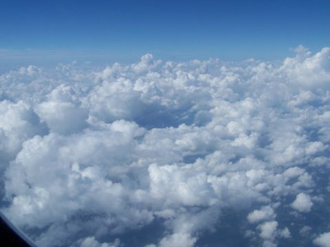 1979 Ford F-150 - An aerial view shows a vast expanse of white clouds against a clear blue sky.