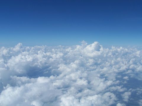 1979 Ford F-150 - A vast expanse of white clouds stretches across the frame under a clear blue sky.